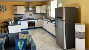 A compact kitchen with a refrigerator, oven, and microwave.