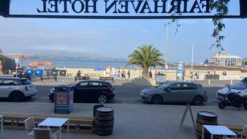 A view of a beachside area with a sign reading "JETTOH INVAHRAI".