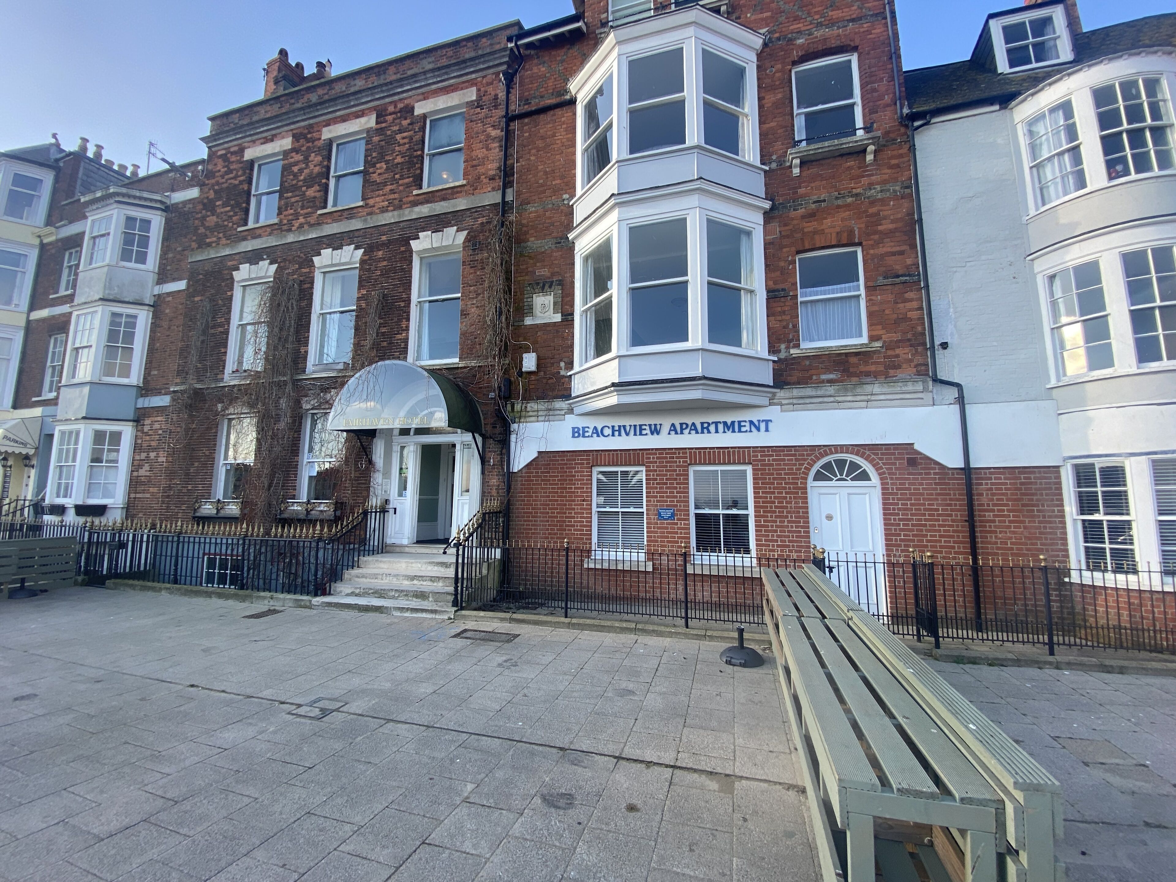 A multi-story building with a sign reading "Beachview Apartment."