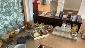 A breakfast buffet with various food items and condiments. - Fairhaven Hotel (Weymouth)