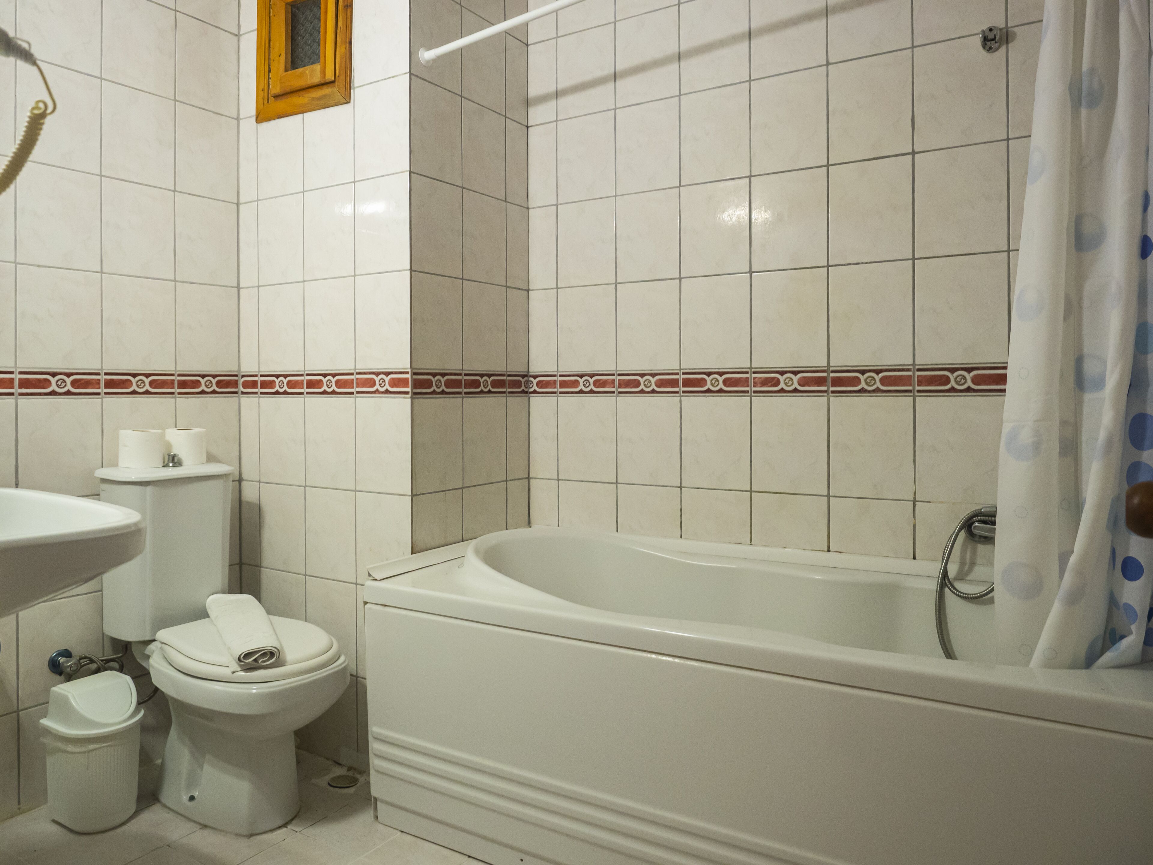 A bathroom with a bathtub, toilet, and sink.