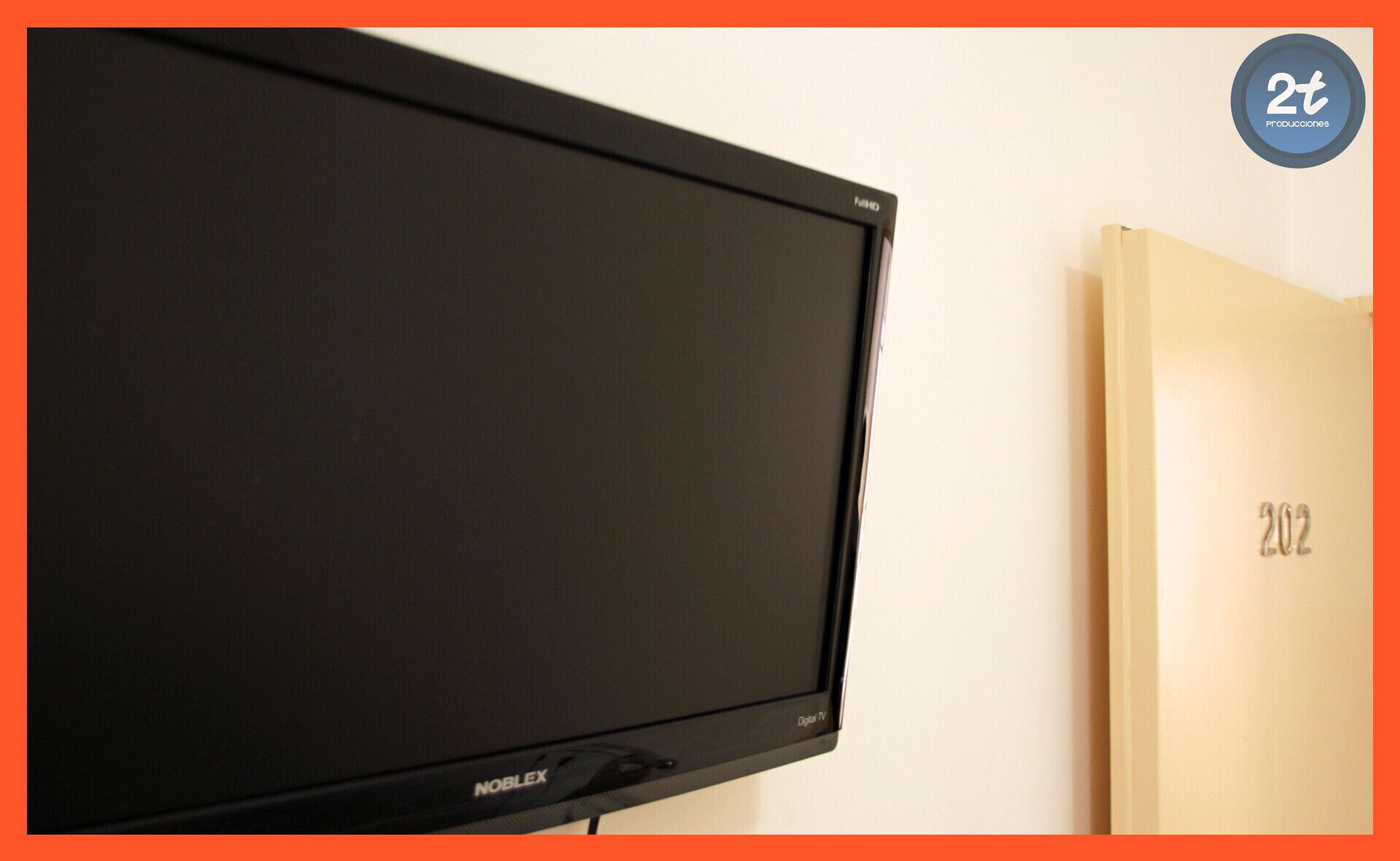 A flat-screen TV mounted on a wall with the brand 'NobleX' visible.