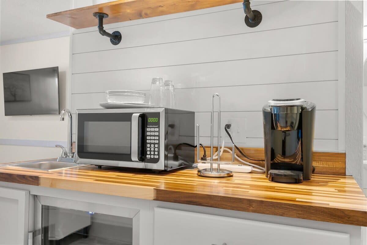 Mini-fridge, microwave, coffee/tea maker, cookware/dishes/utensils