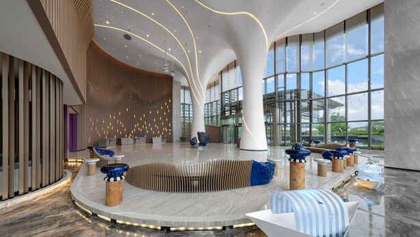 A spacious lobby with a curved seating area, large windows, and modern architectural design. - Renaissance Changzhou Wujin Hotel (Changzhou)