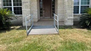 A stone building with a wooden door and a ramp leading to the entrance. - Spacious 4 br getaway. Riviera Beach / Baffin Bay (Riviera)