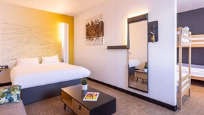 A hotel room with a bed, a small side table, a mirror, and a bunk bed. - B&B Hotel Rennes Parc Expo Aéroport (Bruz)