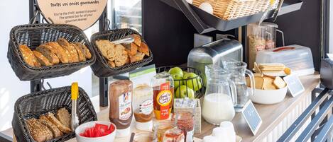 A breakfast buffet with various food items and condiments.