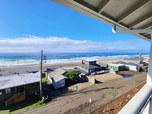 A coastal view with buildings, a beach, and the ocean.