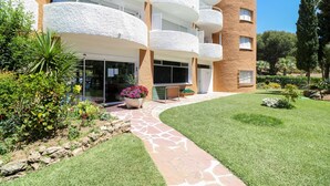 A modern building with multiple balconies, a stone pathway, and well-maintained landscaping. - Renovated studio in Elviria, fantastic sea views (Marbella)