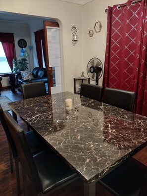 Enjoy meals in this elegant dining area with a large table, comfortable chairs, and warm ambiance.