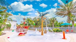 A water fountain area with a ship, palm trees, and a wooden fence. - 106 Festival (Davenport)