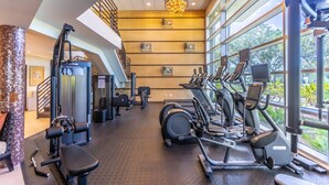 A gym with exercise equipment, large windows, and a modern design. - 215 Little Harbor Inn (Ruskin)