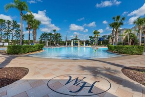 A swimming pool with a gazebo, palm trees, and a clear blue sky. - 2821 Windsor Hills (Kissimmee)