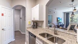 A modern kitchen with granite countertops, stainless steel appliances, and a built-in dishwasher. - 2821 Windsor Hills (Kissimmee)