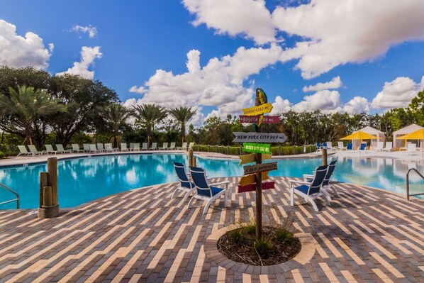 Relax by the pool surrounded by lounge chairs and umbrellas, with easy access to nearby cities.