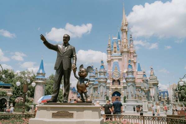 A statue of a man and a child in front of a castle-like building. - 713 Festival (Davenport)