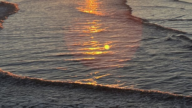 A sunset over a beach with waves reflecting the sun's light. - Stunning River Views-Easy Walk to Beach & Shops-Pool and Day dock!-3BR Townhome (Folly Beach)