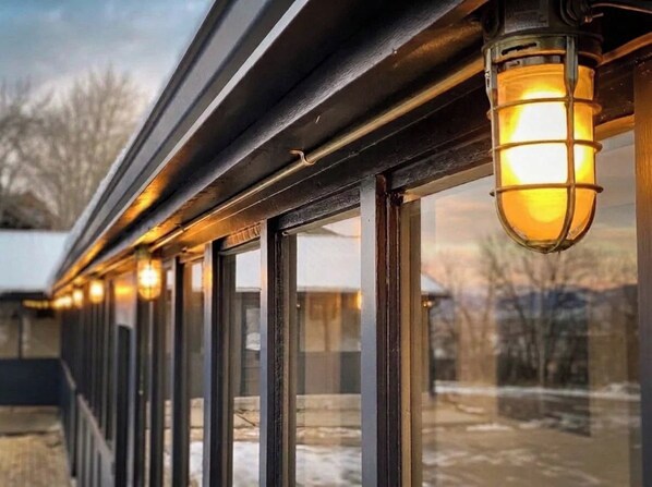 A row of windows with a warm light fixture above them.