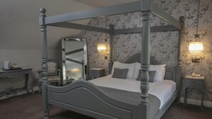 A four-poster bed with a mirror, bedside lamps, and floral wallpaper. - Normanton Park Hotel, Sure Hotel Collection by Bes (Oakham)