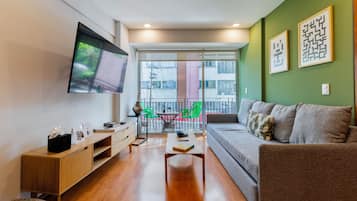Deluxe Apartment, Balcony (301) | Living area | 50-inch flat-screen TV with cable channels, offices
