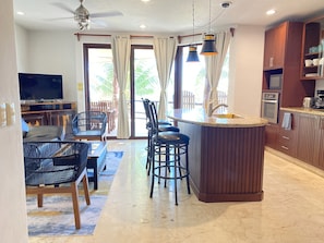 Enjoy cooking and socializing in this spacious living area with a large island and flat-screen TV.