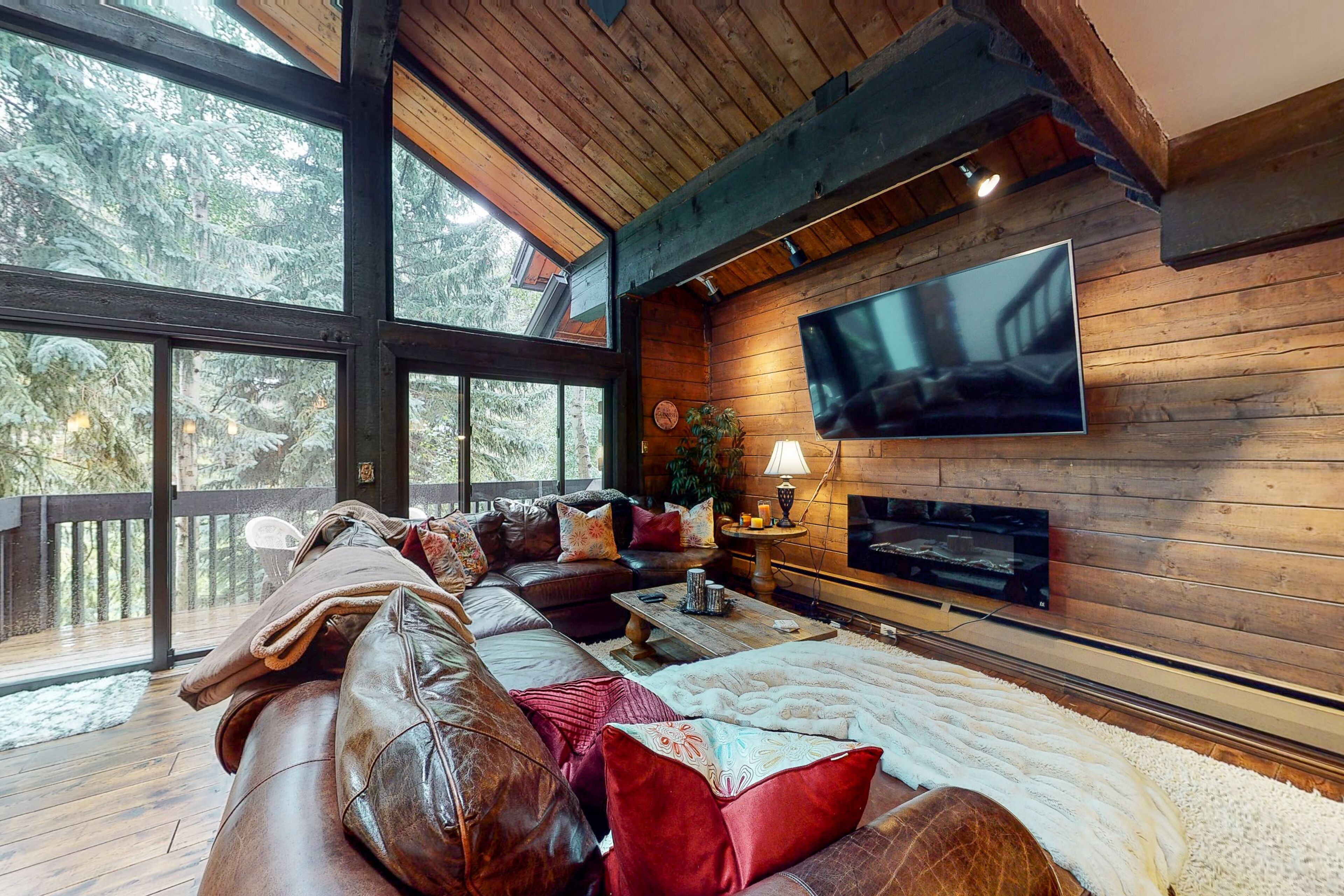 Serene riverfront condo with skiing, mountain view, fireplace, & washer/dryer