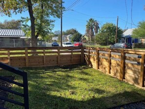 Enjoy an outdoor space with a fenced backyard and lush lawn.