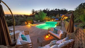 A poolside area with a hot tub, seating, and a view of a house in the background. - Trinity - Secluded Retreat - Pool, Hot Tub, Bocce (Glen Ellen)