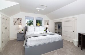 Cozy retreat with a large bed, two bedside tables, and a wardrobe.