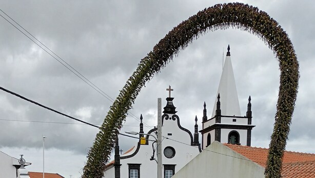 A white building with a cross on top, surrounded by greenery and a curved vine arch. - Charming Cottage in the Heart of the Village, Near Barroque Church (Castelo Branco, Horta, Faial)