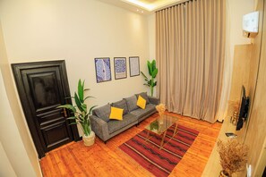 Deluxe Studio Suite | Living area | 43-inch LCD TV with satellite channels, TV, printers - The Kmt collection Hotel (Cairo)