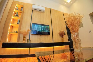 Deluxe Studio Suite | Living area | 43-inch LCD TV with satellite channels, TV, printers