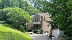 A two-story house with a front porch, a covered garage, and a driveway leading to the entrance. - Pet Friendly Private Home, Located in Forest Ridge (Lincoln)