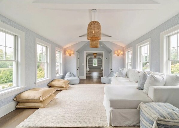Relax in this inviting space with a plush sofa, textured rug, and ambient lighting.