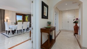 A hotel lobby with a dining area, a console table, and a large mirror. - Nice duplex penthouse with the best sea views, luxury urbanization (Marbella)