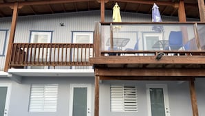 A two-story building with a balcony, large windows, and a wooden ceiling. - Perfect Location, Inside Poblado Boqueron (Boquerón)