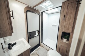 Shower, towels, soap, toilet paper