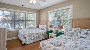 A bedroom with two beds, a ceiling fan, and large windows with blinds. - Family Paradise on Lands End - Private Dock (Saint Helena Island)