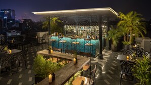 An outdoor bar area with a pool table, bar stools, and a bar counter. - Meritel Hanoi (Hanoi)
