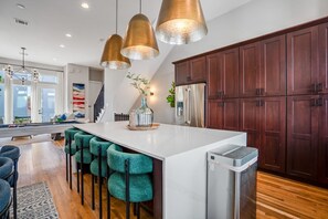 Large kitchen island with 4 barstools, fully equipped with all the kitchen supplies your group needs.