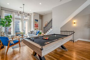 Perfect for entertaining! Large pool table featuring custom snake photo wall.