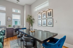 Dining table includes seating for 8 alongside the island bar which seats 4. - Downtown Getaway w/ Rooftop Deck in the Skyline (Houston)