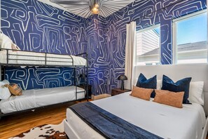 Blue Room features a cozy queen bed, twin bunk bed, and en suite bathroom.