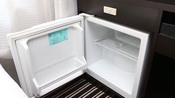 An open refrigerator with a control panel and a note on the door.