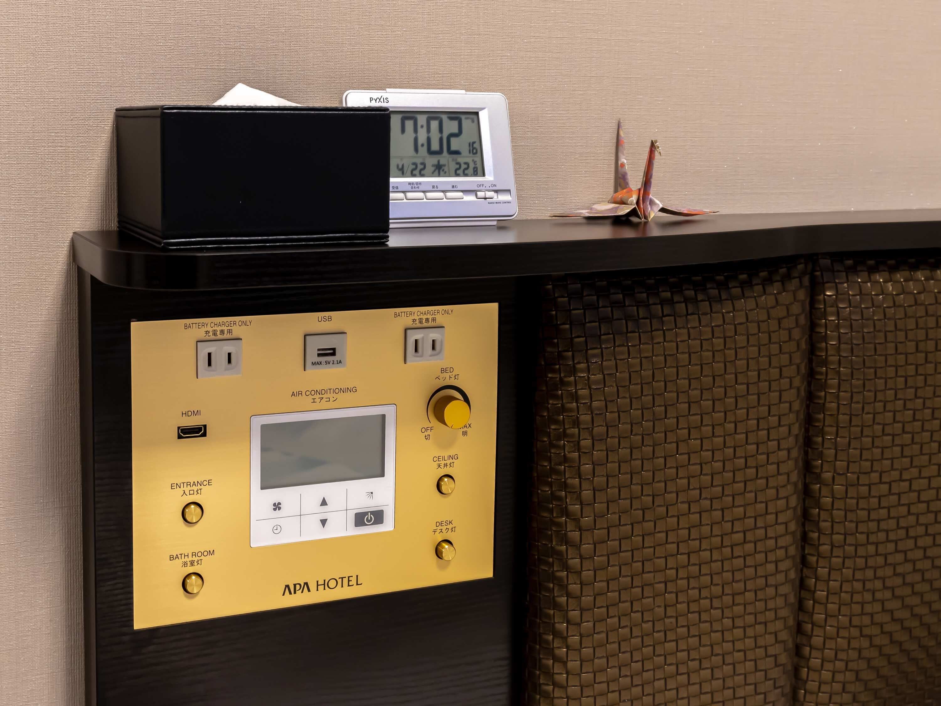 A control panel with a digital clock, a USB port, an HDMI port, and buttons for entrance, bathroom, and desk lighting.
