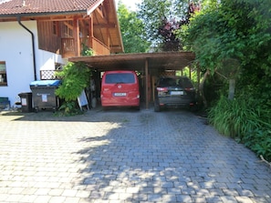 residence with a garage and lush garden.
