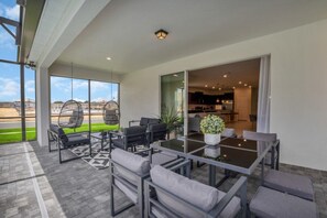 Outdoor dining - Imagine Your Family Renting This Amazing Mansion on Windsor at Westside Resort With the Best 5 Star Amenities, Orlando Mansion 5049 (Kissimmee)