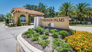 A sign for Veranda Palms with a small building and landscaped garden. - The Secret to Enjoying Your Luxury Villa Holiday on Veranda Palms Resort, Orlando Villa 5550 (Kissimmee)
