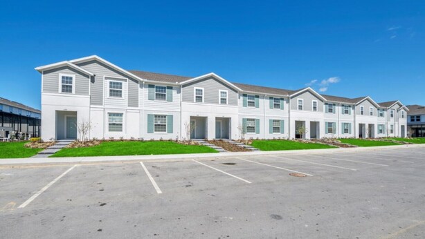 A row of modern, two-story apartment buildings with a parking lot in front. - 5star Villas Close to Disney Orlando Townhome 5643 (Kissimmee)