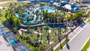 An aerial view of a resort with multiple swimming pools, palm trees, and a golf course. - Fantastic Mansion on Windsor Island Resort, Orlando Mansion 5660 (Davenport)